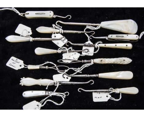 A collection of thirteen small Victorian and later mother of pearl handled button hooks
