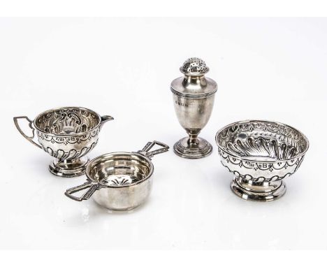 Four 20th century items of silver, including a tea strainer and stand, a small milk jug and sugar basin and a pounce or peppe