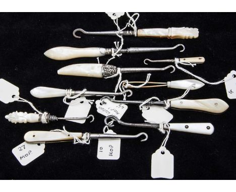Nine small Victorian and later mother of pearl handled button hooks and one very small bone handled example