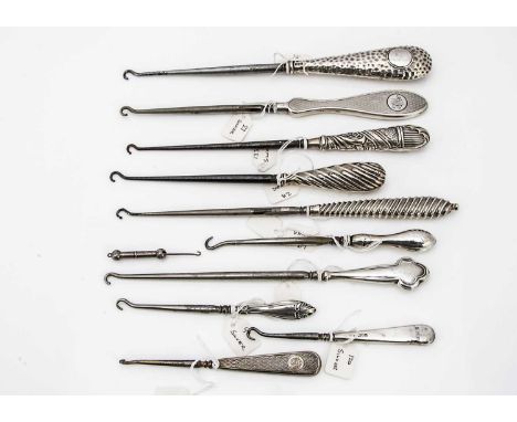 Eleven Victorian and later silver handled button hooks, one small folding example, 7cm, and one long example, 25cm, and other