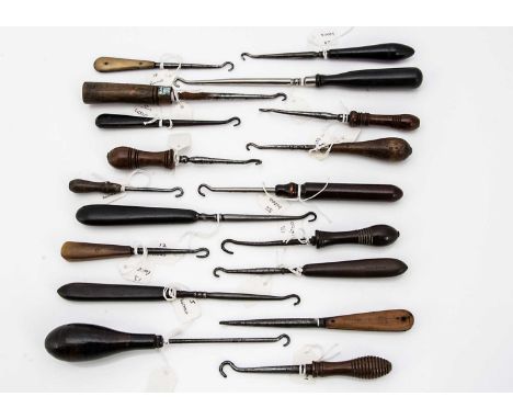 A collection of 18 wooden handled and other button hooks, some turned wood and some horn