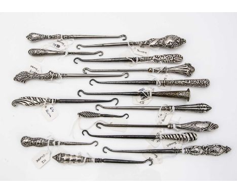 A collection of Victorian and later silver handled button hooks, various designs, most hallmarked, approx 16