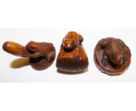 A Japanese carved wood netsuke, in the form of a frog on a gourd, character mark to the underside, 4 cm, and two similar nets