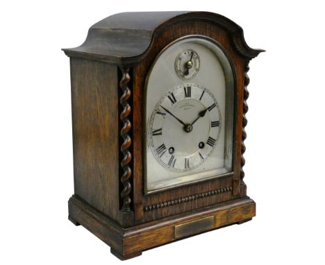 An oak mantle clock, the silvered dial signed Bracher &amp; Sydenham, Reading, with fast/slow dial, the German movement by Wi