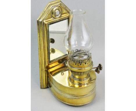 A Victorian brass wall mounted oil lamp, the burner with Best English Make adjusters, to a horseshoe shape reservoir to a mir