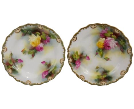A Royal Worcester pair of dessert plates, both with painted floral decoration and gilt edges, signed M Blake, puce date code 