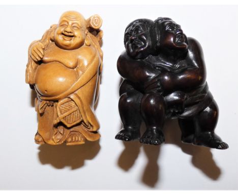 A Japanese carved hardwood netsuke, in the form of Sumo wrestlers, inset signature, height 5 cm and another carved wood netsu