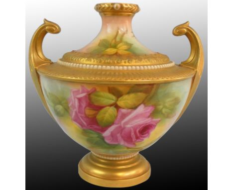 A Royal Worcester blush ivory pattern vase of Grecian urn form, with a pair of upright gilt scroll handles, the body with flo