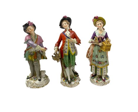 Pair of Naples figures, she holding bird cage with bird perched upon her arm, he holding game, each approximately H23cm, toge