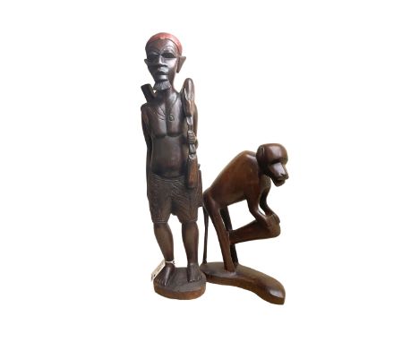 Two African carved hardwood figures, the first carved as a monkey, H43cm, the second as a male figure, H70cm