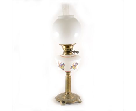 A cast brass and opaque glass oil lamp, conceivably Russian, later shade and chimney