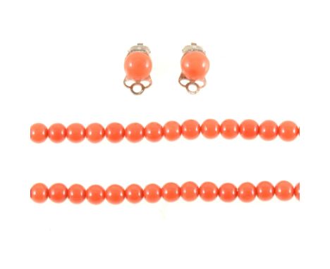 A coral bead necklace, one hundred and nine 6mm coral beads strung into a single row 60cm long and fitted with a yellow metal