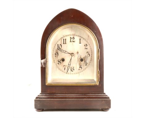 Mahogany lancet shaped mantel clock, arched silvered dial with Arabic numerals, English movement striking on a gong, raised o