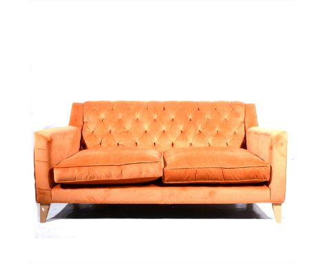 A button rust velvet two-seater settee, beechwood supports, length 177cm.