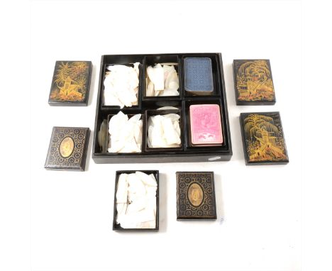 A collection of Chinese mother of pearl gaming counters, in a black lacquered case, the latter damaged.