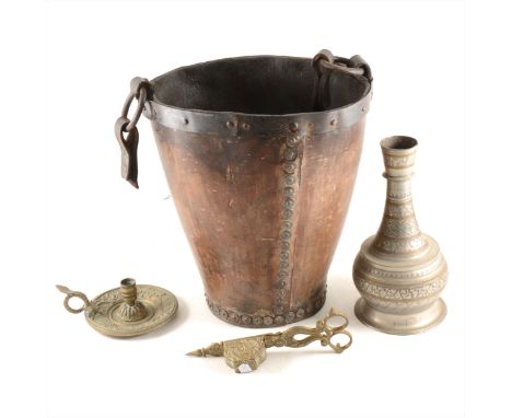 An old leather fire bucket, 31cm; an Indo-Persian metal vase; candle-snuffers and chamber stick.