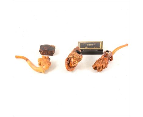 Three figural smoking pipes, and two small tortoiseshell boxes, one with mother of pearl and ivory inlay, both with losses. (