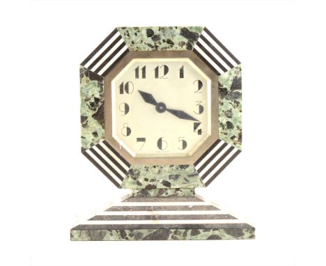 A French Art Deco marble cased mantel clock, octagonal silvered dial with Arabic numerals, enclosed in a marble frame with gr
