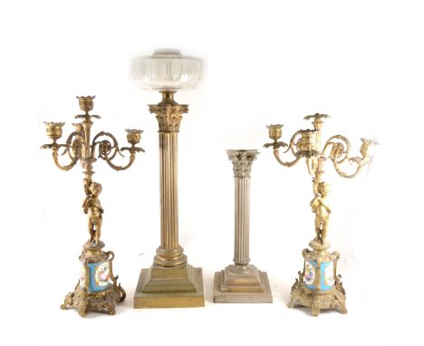 A pair of French style gilt metal candelabra, with blue Celeste porcelain plinth sections, branches supported by cherubs, 49c