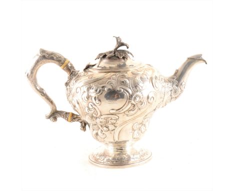 An ornate William IV silver teapot, William Hewitt, London 1835, inverted pear shape form, repouss chased floral and foliage 