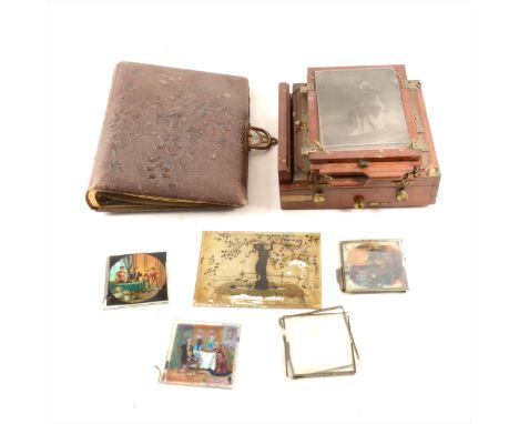 A mahogany half-plate camera, incomplete; a small collection of lantern slides; ambrotype photograph; and an Edwardian photog