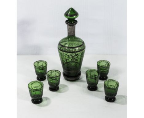 A green glass decanter and six glasses