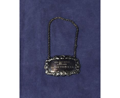 A silver decanter label