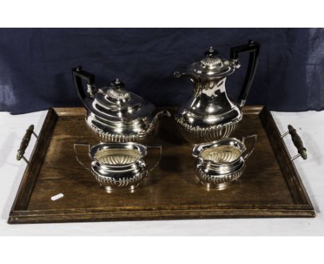 A four piece silver plated tea service and a wooden tray
