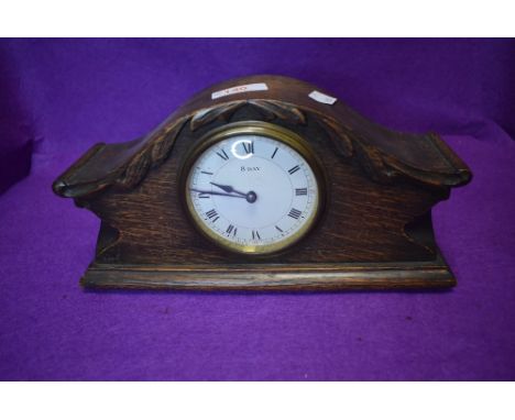 An oak cased mantle clock having 8 day movement