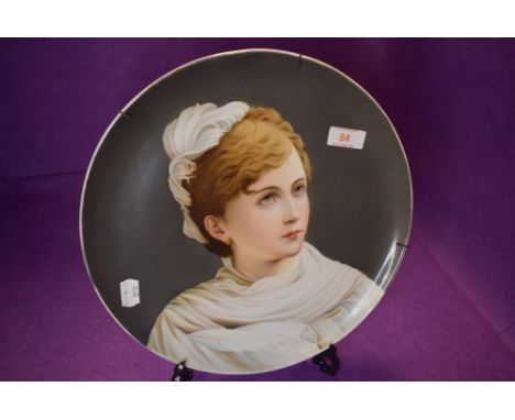 A fine porcelain plate having a hand decorated portrait of Russian styled lady