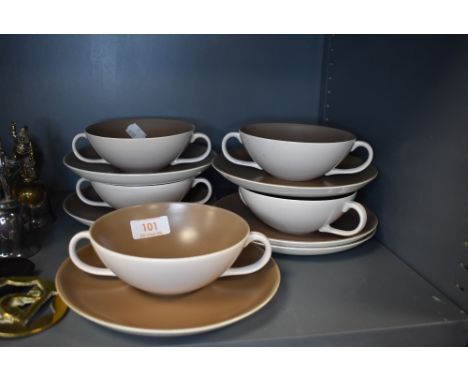 A selection of soup cups and saucers by Poole pottery having pink and cream colourways