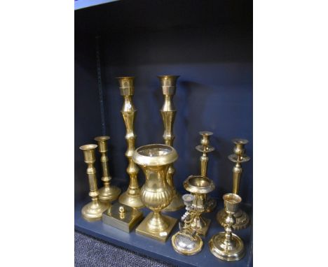 Three sets of brass cast candle sticks also and anchor styled cnadle stick and two mantle urns