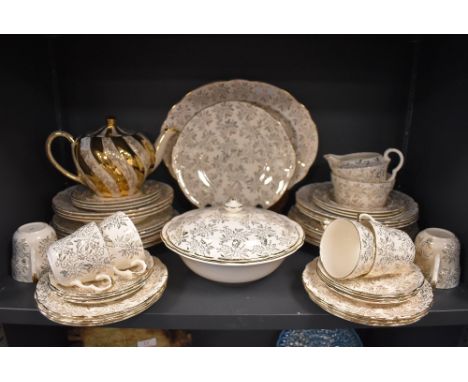 A part dinner and tea service by Washington Pottery, Hanley, in a cream ground a gilt design