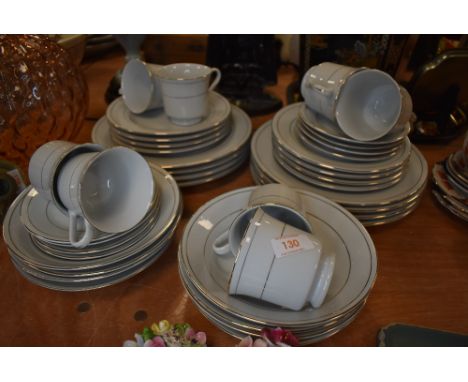 A porcelain part tea and dinner service in a white ground with gilt detailing