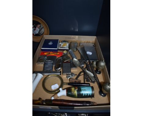 A selection of curios and trinkets including various pocket cigarette lighters and pipe etc
