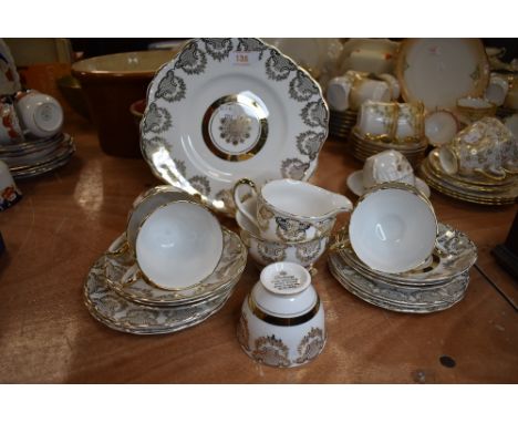 A part tea service by Dubany in a gilt and white ground design bone China 22kt decoration