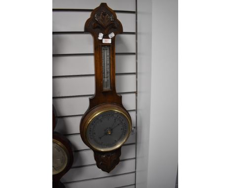 An antique banjo style barometer having an oak case and mercury filled