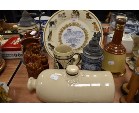 A selection of ceramics including German beer steins and ceramic foot warmer