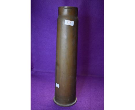 A large brass cased military ammunition shell dated 1938