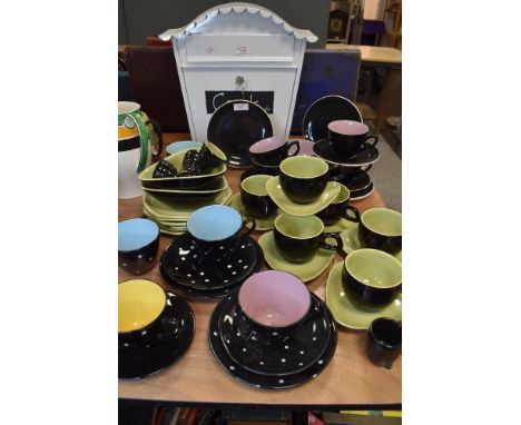 A selection of un marked tea cups and saucers including polka dot and two tone
