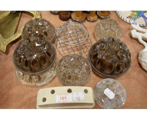 A selection of glass and ceramic rose or flower holders