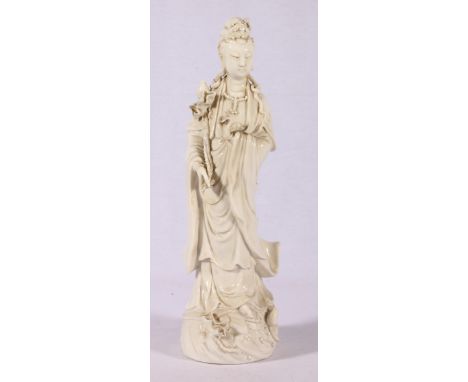 Chinese blanc de chine figure of Quan Yin holding a lotus branch. CONDITION REPORT: The size of the figure is 29 x 8cm, there