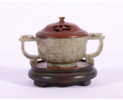Chinese 19th Century carved jade two handled censer in mottled grey brown and celadon jade, the turn loop handle carved with 