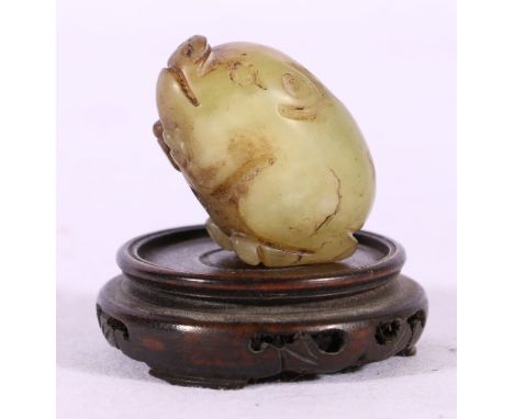 Chinese 19th Century jade carving of a pig in grey green and brown jade, pierced as a toggle, 4cm x 2.5cm, wooden stand.