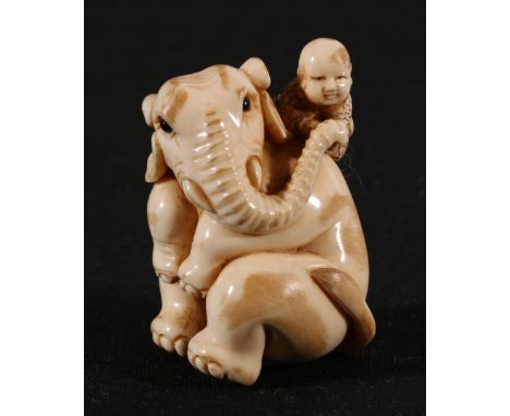 Early 20th century Japanese ivory netsuke of a little boy sitting on an elephants shoulder, 4.5cm, Taisho.