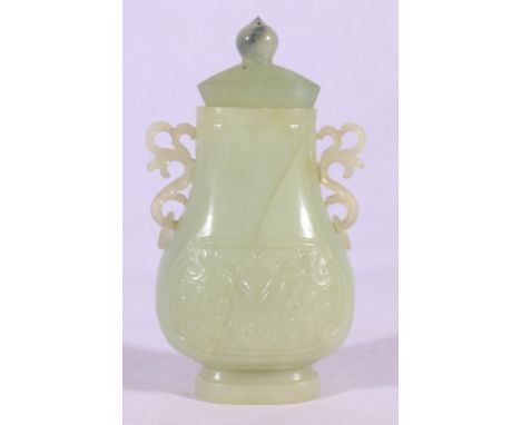 Chinese green jade vase with scroll handles and low relief decoration in archaic style, also a jade lid. 18cm high, 9cm wide