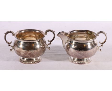 Elizabeth II silver sugar bowl and cream jug, Birmingham 1964, makers Walker and Hall, 398g.