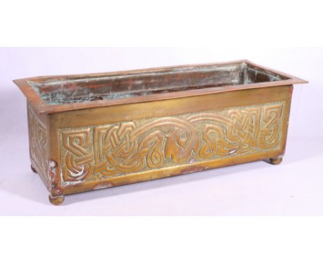 Arts and crafts brass planter of rectangular shape decorated in the Celtic style raised on four ball feet, 50cm wide. CONDITI