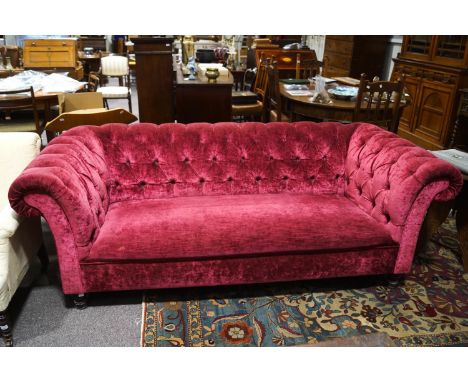 A Victorian style sofa with button back and turned legs