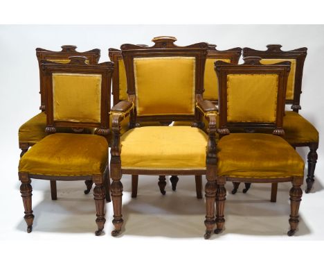 A set of seven Victorian dining chairs with mahogany show frame on turned fluted and reeded legs, with brass and ceramic cast